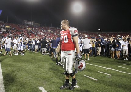 UNLV offensive lineman Jason Heath looks over his shoulder as UNR fans celebrate on his field after losing, 49-27.