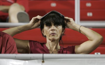 UNLV fan Marisa Vincent covers her head with a program during the closing minutes of the second half.