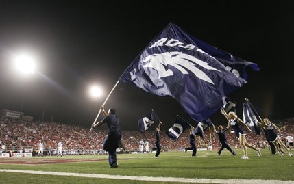 UNR cheerleaders carry their flags after a UNR touchdown during the second half.