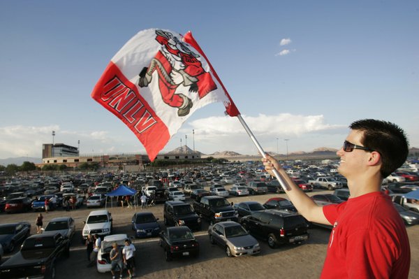 UNLV student Erik Forsyth waves his flag while standing on ...