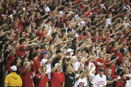 UNLV fans cheer as their team takes the field against UNR at Sam Boyd Stadium.