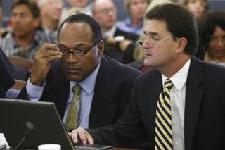 O.J. Simpson, left, and his attorney Yale Galanter appear during Simpson's trial at the Clark County Regional Justice Center Monday, Sept. 29, 2008 in Las Vegas, Nev. Simpson is charged with a total of 12 counts including kidnapping, armed robbery and assault with a deadly weapon stemming from an alleged incident involving the theft of his sports memorabilia.