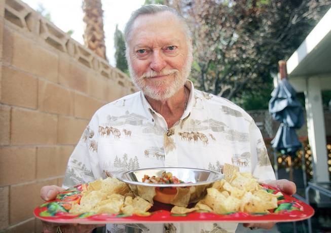 Bob Wiseman holds out his salsa, made from scratch and his own salsa powder, at his home in Silverado on Sept. 17. 