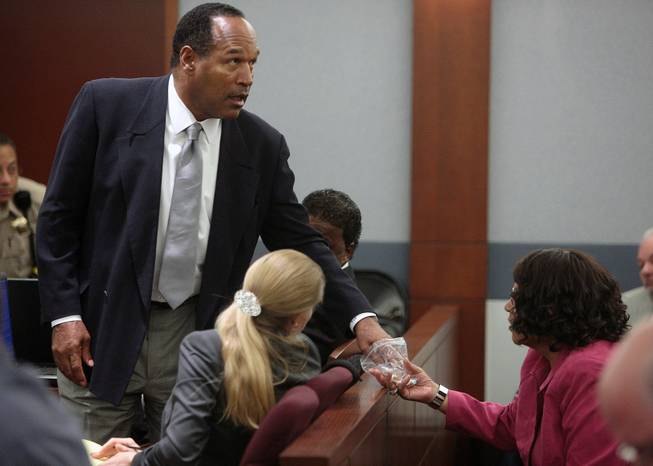 O.J. Simpson, left, and his sister Carmelita Durio appear during Simpson's trial at the Clark County Regional Justice Center, Wednesday, Oct. 1, 2008 in Las Vegas. Simpson faces 12 charges, including felony kidnapping, armed robbery and conspiracy. 