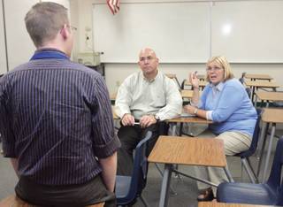 Josh Adams, left, talks with parents David and Becky Parry about what they can expect from their son Michael's computer science class during open house at Green Valley High School on Sept. 23.