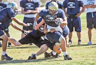 Foothill High running back Algernon Sewell is tackled during practice Sept. 24.