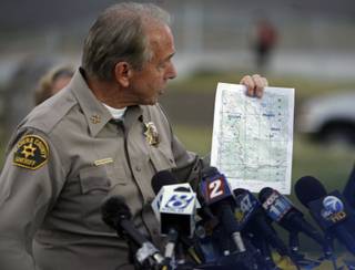 Madera County Sheriff John Anderson holds a topographic map showing the site of a plane crash during a news conference at the Mammoth Lakes Airport on Thursday, Oct. 2, 2008 in Mammoth Lakes, Calif. Searchers found the wreckage of Steve Fossett's plane in California's rugged Sierra Nevada just over a year after the millionaire adventurer vanished on a solo flight, and the craft appears to have hit the mountainside head-on, authorities said. 