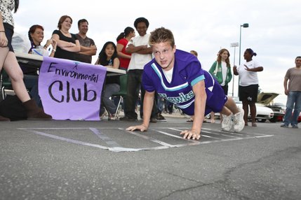 Determined to win the strength contest, cheerleader Jordan Troyer pushes himself to exceed 100 push ups in the Environmental Club's contest during the homecoming tailgate party at Silverado High School. Being Silverado's first year to institute student recycling, 75 percent of the contest proceeds will go toward purchasing recycling bins for the school and 25 percent will go to the contest winner.