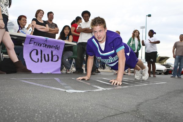 Determined to win the strength contest, cheerleader Jordan Troyer pushes ...