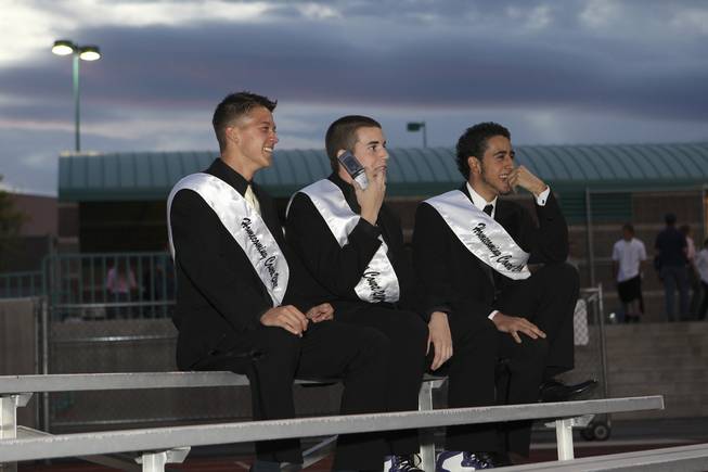 From left, senior homecoming king candidates Ryan Cross, Aaron Barry and Fernando Valenzuela sit on the bleachers Friday, waiting to escort the homecoming queen candidates during Silverado's homecoming parade. The three have been friends since seventh grade.