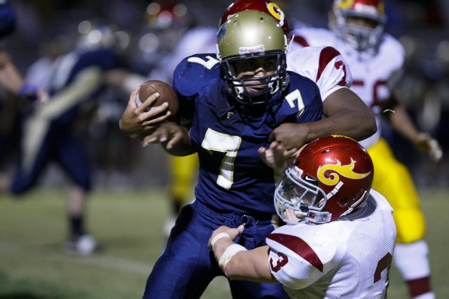 Del Sol's Dezrick Reed (7), background, and Derek Eamon (3) go for a tackle against Foothill's Connor Afoa (7) during Friday night's game at Foothill.