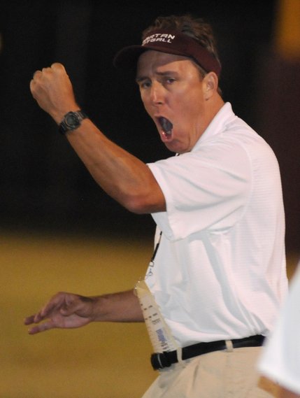 Spartans special teams coach Ron Stigler celebrates after his team makes a big stop against a fake punt by the Palo Verde Panthers near the end of the first half of Friday's game at Cimarron-Memorial High School.