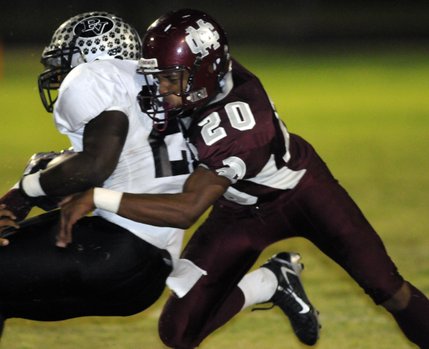 Spartan defensive back Timothy Hassen (20) drives into Palo Verde running back Chaz Thomas during a second-half play Friday at Cimarron-Memorial High School.