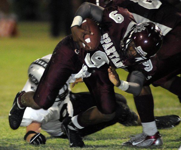 Spartans quarterback Kenneth Banks is tripped up during an overtime ...