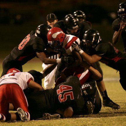 The Wildcat defense swarms Vikings quarterback Kerwyn Williams during Friday's game at Las Vegas High School. 