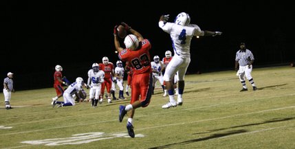 Liberty's Michael Reveles (83) intercepts a ball intended for Basic's Billy Weathers (4) during Friday's home game.