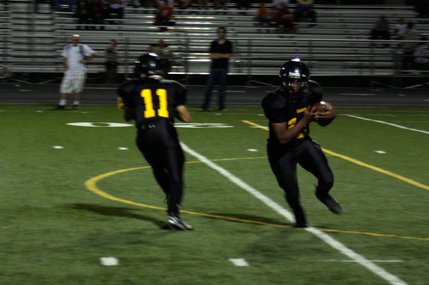 Clark senior Quincy Hatcher (12) runs the ball after receiving it from quarterback Anthony Lotta (11).