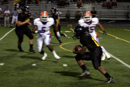 Clark running back Quincy Hatcher tries to dodge Gorman defenders Alex Turner (5) and Evan Palelei (55) on Oct. 3. Turner and Palelei are two of the most sought after defensive recruits for the class of 2010.