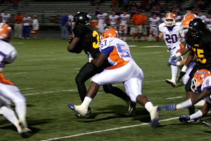 Bishop Gorman's Jalen Grimble (57) takes down Clark's Keneal Riley during the first quarter of Friday's game at Clark.