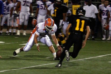 Bishop Gorman's William Fitzgerald (58) grabs a fumbled ball before Clark's Anthony Lotta (11) can get to it.