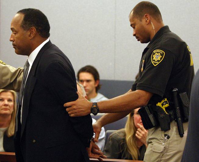 O.J. Simpson is taken into custody after being found guilty on all 12 charges, including felony kidnapping, armed robbery and conspiracy at the Clark County Regional Justice Center in Las Vegas.