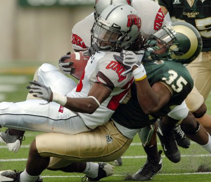 UNLV wide receiver Michael Johnson, left, is dragged down by Colorado State defender Ivory Herd on Saturday. Colorado State won 41-28. 