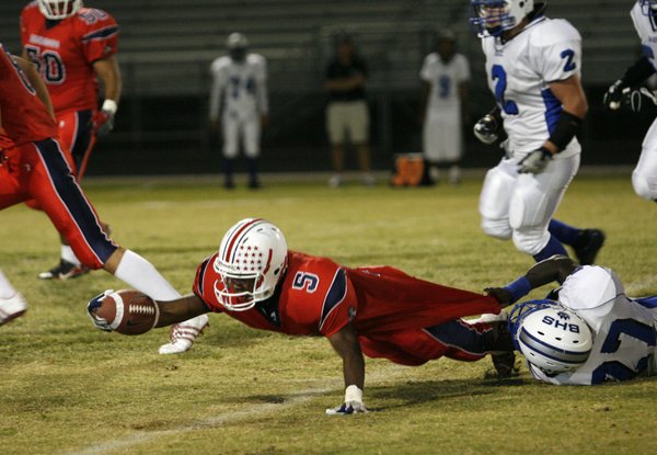 Liberty's Ty Byrd (5) reaches for an extra inch as ...