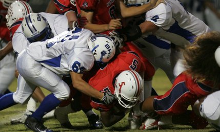 Liberty's Ty Byrd (5) is tackled during Friday's game against Basic.