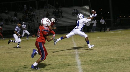 Basic's Billy Weathers (4) reaches for a pass during an away game against Liberty on Friday.