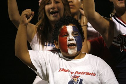 A Liberty fan cheers during the school's homecoming football game Friday against Basic.
