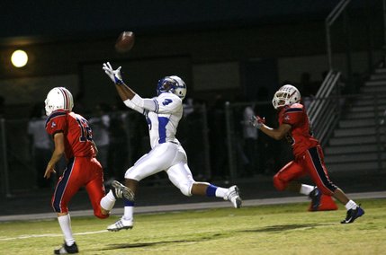 Basic's Billy Weathers (4) reaches for a pass during Friday's away game against Liberty.