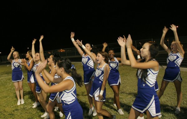 Basic cheerleaders react after their team scores a touchdown Friday ...