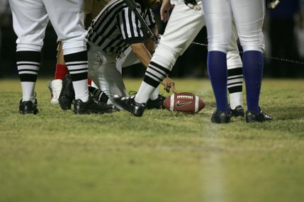 Officials measure a play during Friday's football game at Liberty High School.