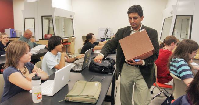 Professor Sandip Thanki hands out clickers to his students at the beginning of class at Nevada State College.