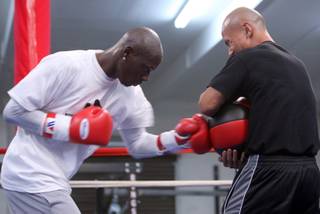 IBF light heavyweight champion Antonio Tarver, left, of the U.S. hits a medicine ball held by strength trainer Raphael Ruiz during a work out at the Mayweather Boxing Club in Las Vegas Tuesday, October 7, 2008. Tarver will defend his title against undefeated former WBC light heavyweight champion Chad Dawson at the Palms on Saturday.