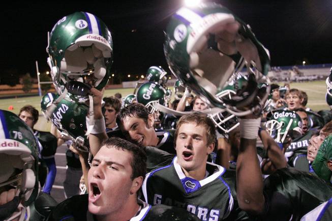 Nick Libonati, center, cheers with his team after a win at home against Foothill High last month. His father sends game highlights to college coaches, friends and family members after editing the raw footage on his home computer.