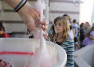 Eighth-grader Jessica Raymond makes cotton candy for a long line of students during Jack and Terry Mannion Middle School's fall festival Oct. 8.