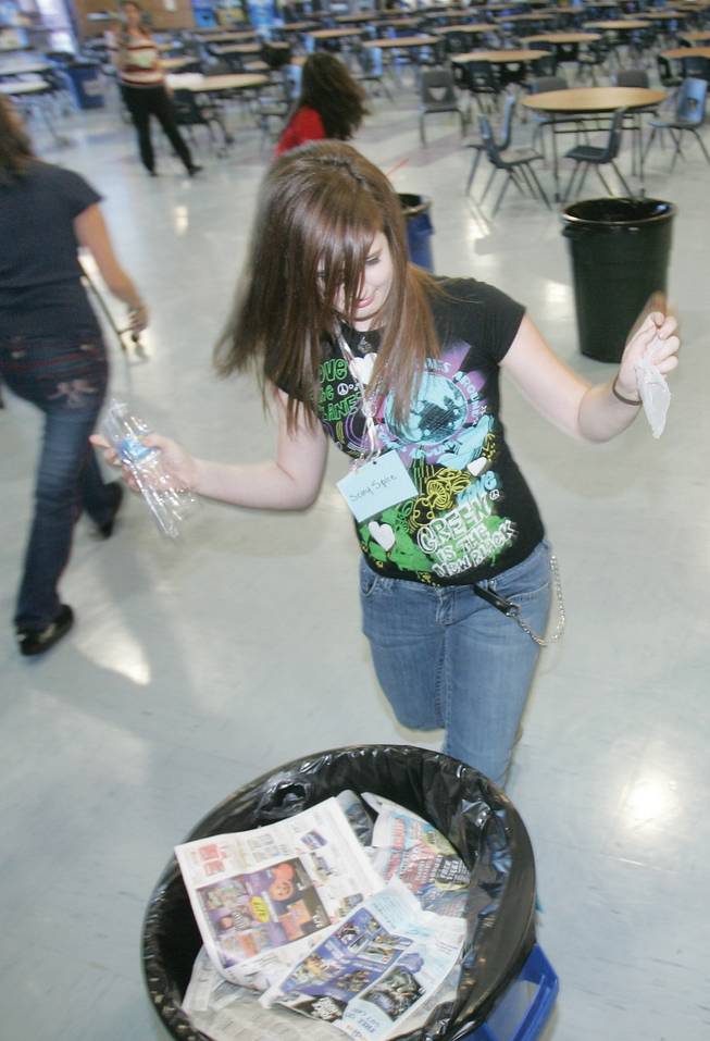 Liberty's Rayana Barnes races to sort trash against classmates during a regional recycling meeting at Liberty High School on Monday.