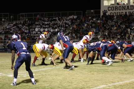 The Dragons and the Cougars get ready for a play at the line of scrimmage during Friday night's game at Coronado.