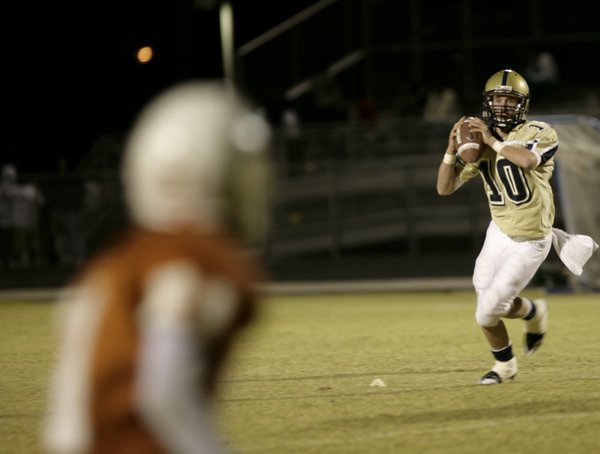 Chris Spencer, Cheyenne's backup quarterback, looks for a receiver at ...