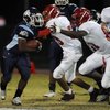 Bulldogs running back David Vance (2) tries to turn the corner on the Aggies during Friday's game at
