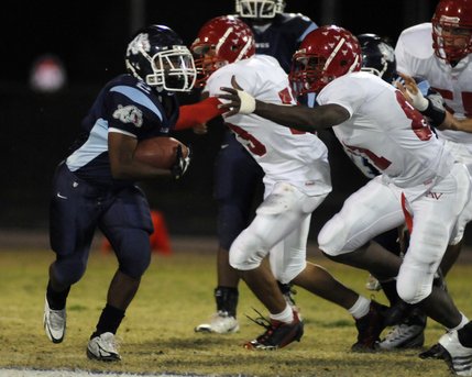 Bulldogs running back David Vance (2) tries to turn the corner on the Aggies during Friday's game at Centennial High.