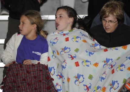 From left, Siara Roberts, Rachel Meservey and Joyce Gardner bundle up in blankets during a cool Friday evening spent cheering on the Centennial Bulldogs.