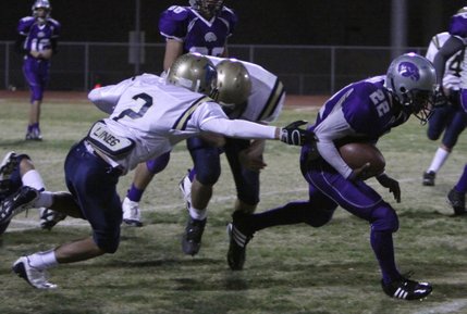 Dariouse Gravely breaks two tackles during Friday night's game against Foothill.