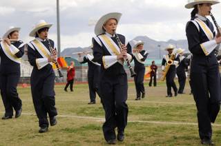 Members of the Boulder City High School marching band and color guard perform during the 3rd annual Showdown at Silverado Field Tournament on Saturday.