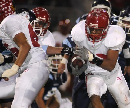 Aggies running back Gabe Tony (32) looks for a seam behind his blockers during a second-half carry against the Bulldogs at Centennial High School on Friday night.