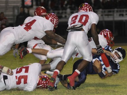 Bulldogs running back Jimmy Zeh (25) is mobbed by Aggies defenders during a botched play in the second half of a game at Centennial High on Friday night.