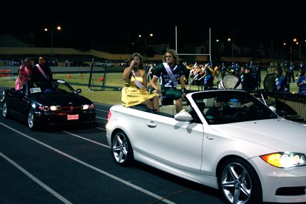 The Green Valley homecoming court rides past the crowd during halftime of Friday's football game.