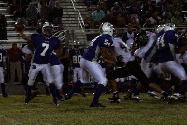 Basic quarterback Robby Faiman (7) passes the ball to a ...