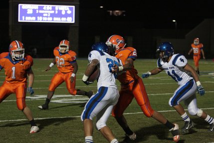 Sierra Vista's Tama Gago is tackled by Bishop Gorman's Brandon Devlin (1) and Victor Belen (22) during Friday's game at Bishop Gorman. 